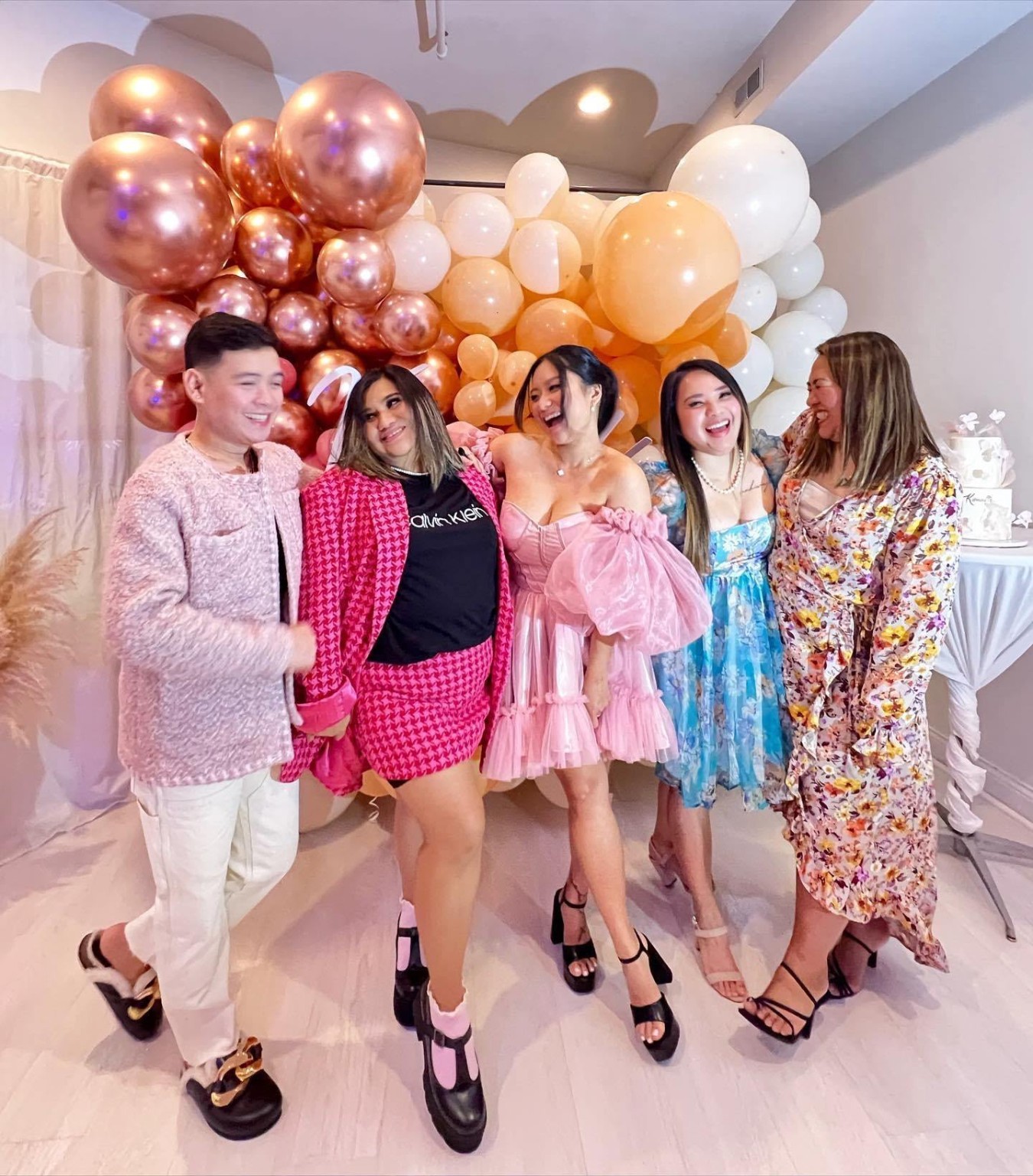 Guests celebrating in front of a balloon installation at Loft329